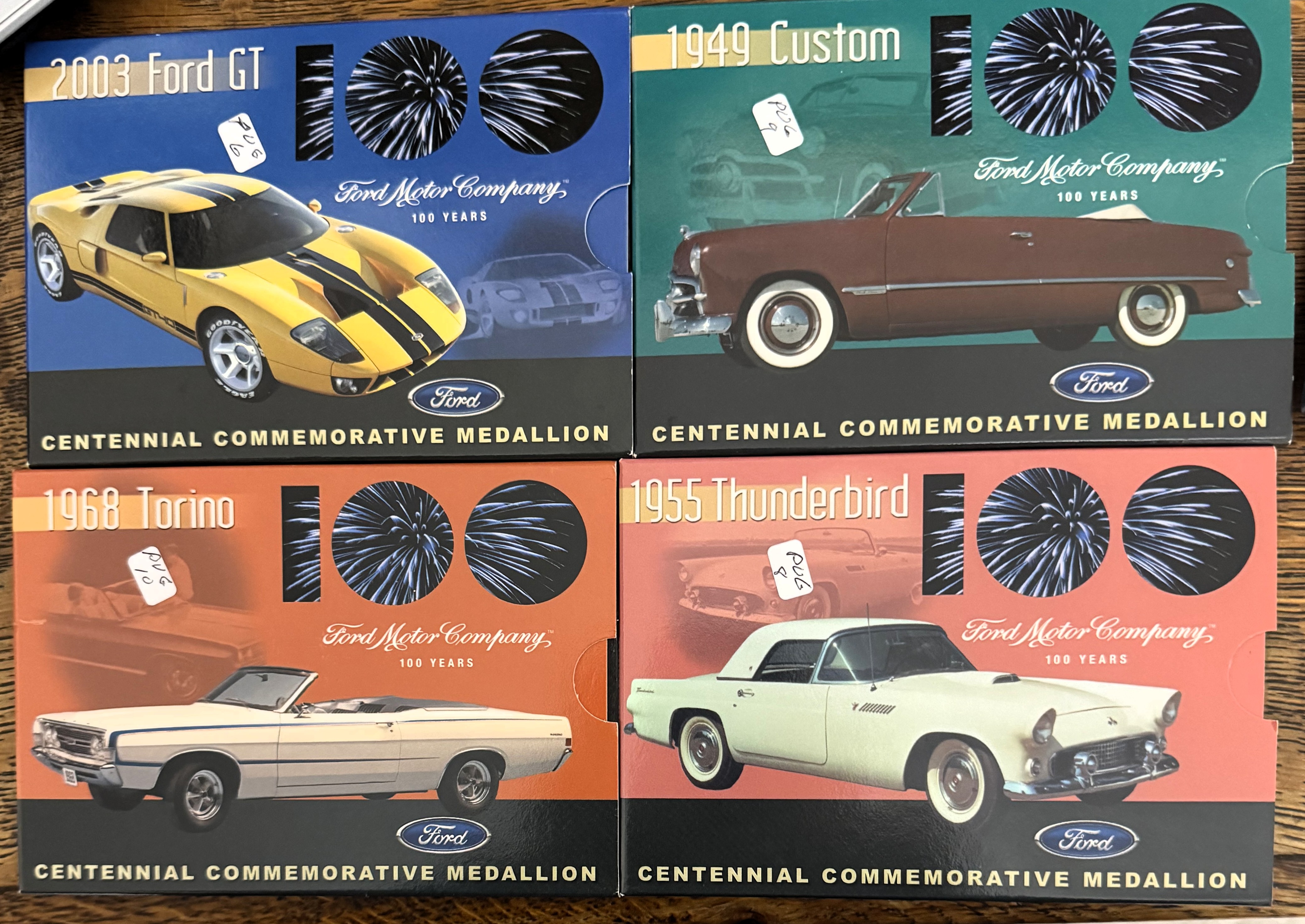 FORD 100 YEARS CAR ANNIVERSARY, (4) MEDALLIONS, 1949, 1955, 1968, 2003, IN (4) ORIGINAL PKGS, LIKE NEW