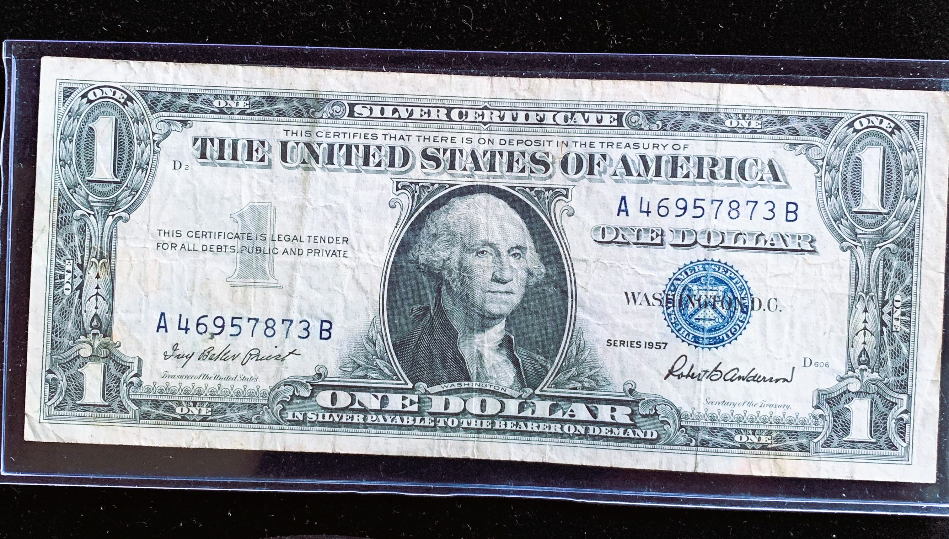 1957 SERIES $1 DOLLAR SILVER CERTIFICATE BLUE SEAL IN SLEVE