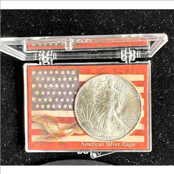 1986 .999 1oz FINE AMERICAN SILVER EAGLE $1 DOLLAR, (FIRST YEAR) BU COIN IN A CASE